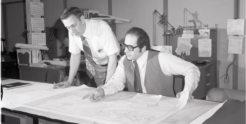 Engineers reviewing a technical drawing in the design office