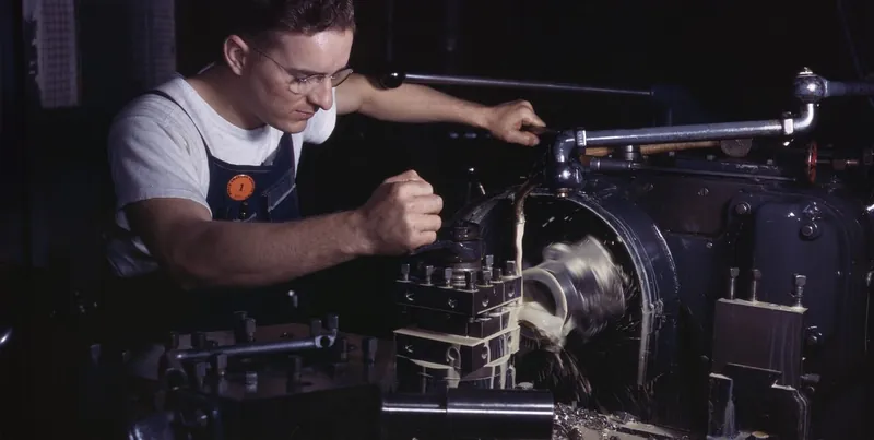 Machinist operating a precision lathe