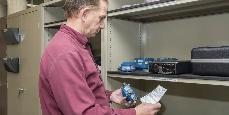 Quality inspector checking an instrument with a caliper