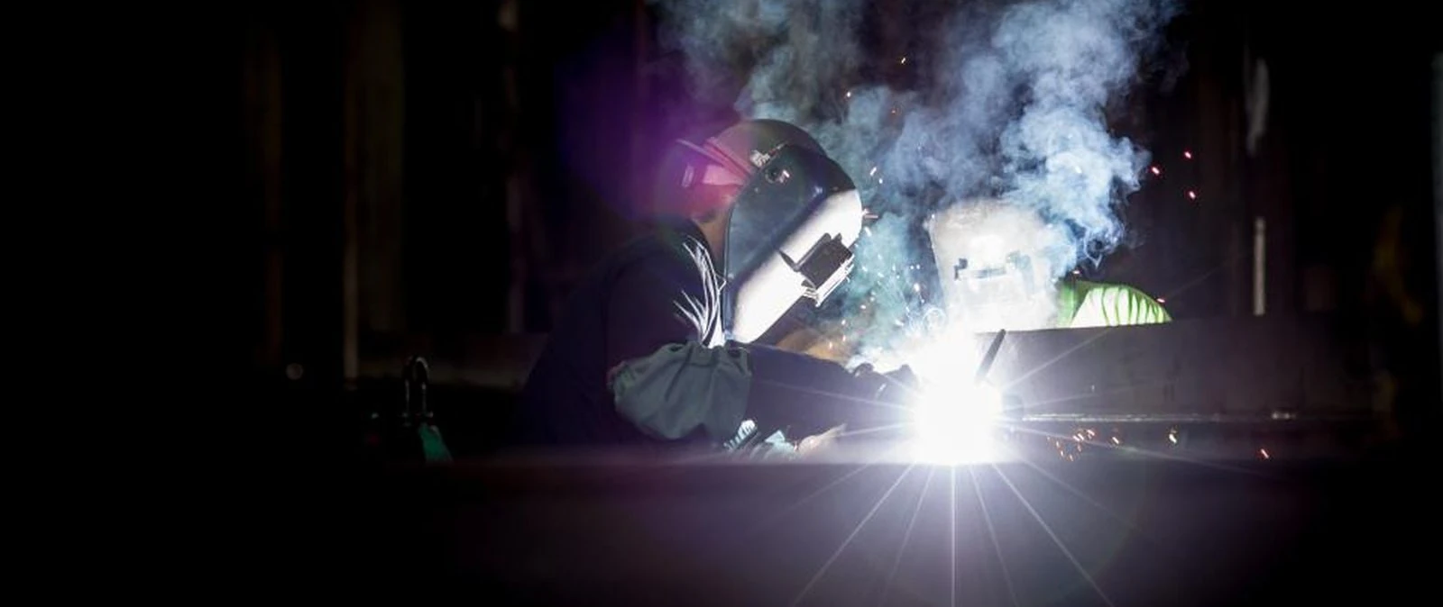 Engineer inspecting process machinery on the manufacturing floor